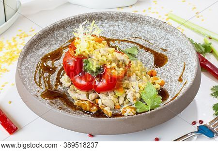 Chicken Breast With Bulgur Baked In Pepper In A Gray Ceramic Plate In A Restaurant. Selective Focus.