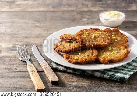 Traditional Jewish Latkes Or Potato Pancakes On Wooden Table.copy Space