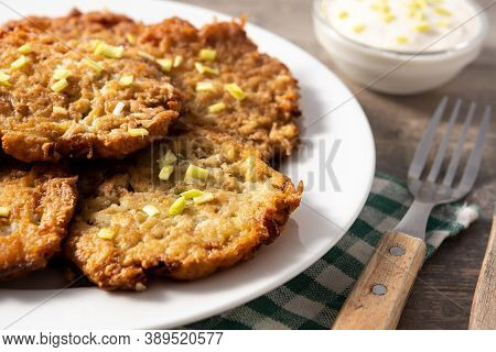 Traditional Jewish Latkes Or Potato Pancakes On Wooden Table.close Up