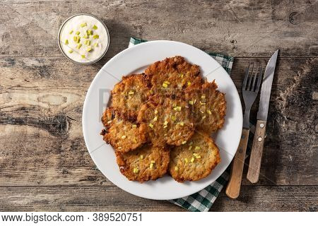 Traditional Jewish Latkes Or Potato Pancakes On Wooden Table. Top View