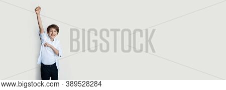Caucasian Boy Gesturing The Yes Sign On A White Studio Wall With Free Space While Wear Casual Clothe