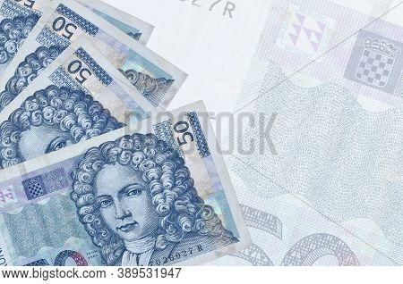 50 Croatian Kuna Bills Lies In Stack On Background Of Big Semi-transparent Banknote. Abstract Busine