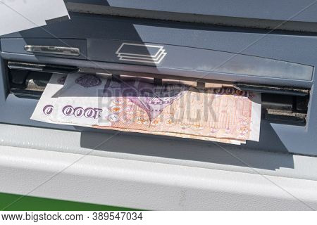 Withdraw Money From Atm. 100 Isk Banknotes At Atm Machine.