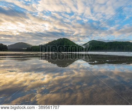 Reflection Over The Sand As The Tide Goes Out At San Josef Bay, Vancouver Island, British Columbia, 