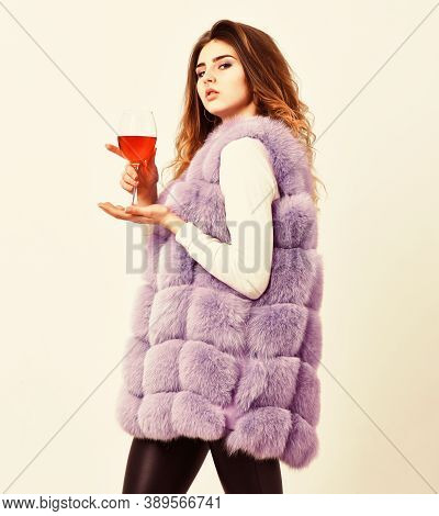 Reasons To Drink Red Wine In Wintertime. Woman Drink Wine. Girl Fashion Makeup Wear Fur Coat Hold Wi
