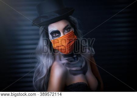 Spooky portrait of woman in halloween gotic makeup wearing protective mask