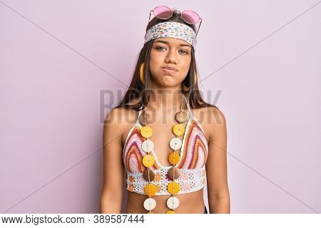 Beautiful hispanic woman wearing bohemian and hippie style puffing cheeks with funny face. mouth inflated with air, crazy expression. 