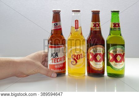 Calgary, Alberta, Canada. Oct 12, 2020. A Person Holding A Mexican Beer With Various Popular Beers F