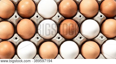 Close-up View Of Raw Chicken Eggs In Egg Box On White, Beige, Isolated Background. Mix White And Bro
