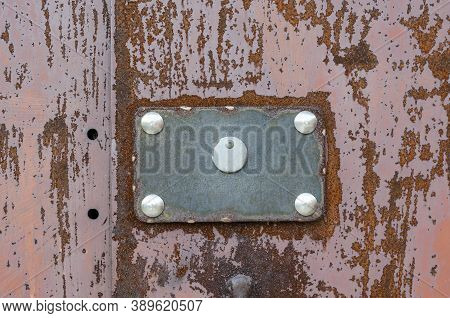Rusty Sheet Of Metal With A Rectangular Plate. Red Metal Background With Peeling Paint. Creative Abs