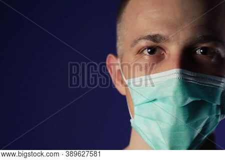 Caucasian Sick Man In A Medical Gause Mask With Palm On His Head