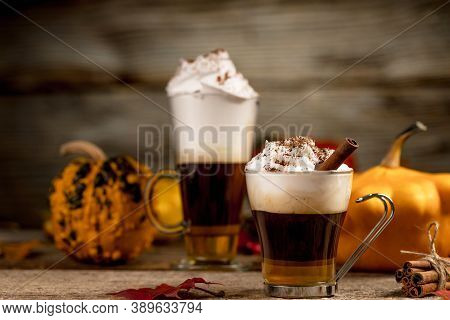 Pumpkin Latte With Cinamon Powder And Delicious Flavours On The Old Textured Wood Table With Colorfu