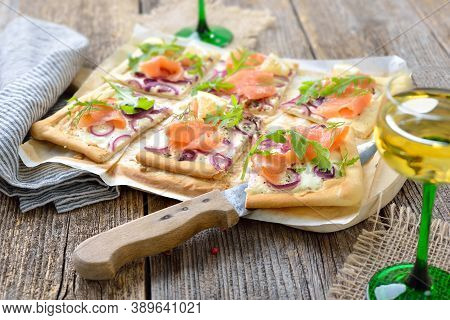 Tarte Flambee From Alsace With Smoked Salmon And Rocket Leaves Served With Local Alsatian White Wine