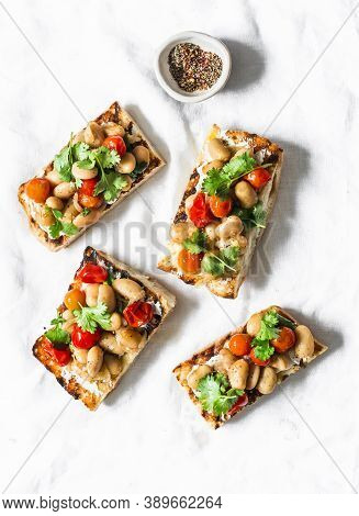Goats Cheese Crostini With Garlicky Beans On A White Background, Top View
