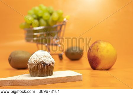 Fresh Muffin Sprinkled With Powdered Sugar. Background For Text. Fresh Fruit Muffin And Fruit