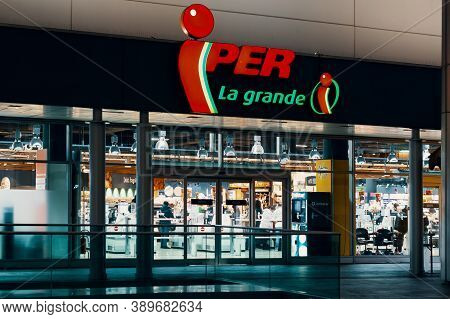 Iper Logo And Showcase Of The Store At Night. Iper Is The Brand With Which Finiper Spa, Operates, A 
