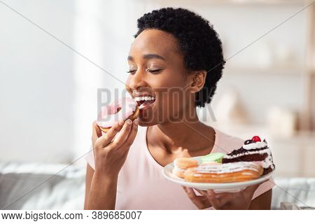 Diet Breakdown, Cheat Meal And Imbalanced Nutrition Concept. Beautiful Young Black Woman With Plate 