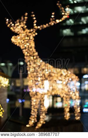 Blurred Lights Of Christmas Installation - Defocused Lights Of Deer On Night City Background. Christ