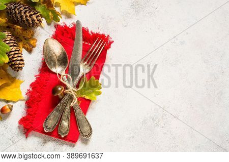 Autumn Table Setting With Silverware, Autumn Leaves And Fall Decorations At White Table. Top View Wi