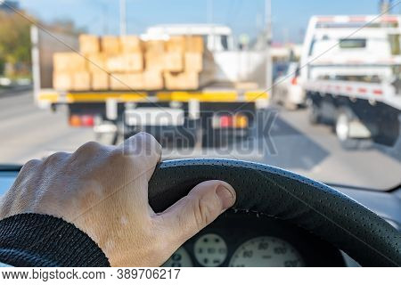 View Of The Driver Hand On The Steering Wheel Of A Car That Is In A Traffic Jam At A Traffic Light I