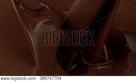 Detail of pouring hot chcocolate with splash. Studio macro shot.