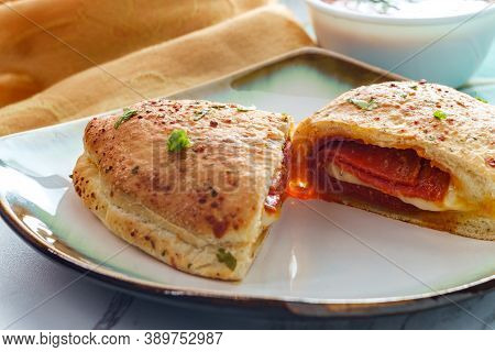 Italian Pastry Pepperoni And Cheese Calzone With Tomato Marinara Dipping Sauce