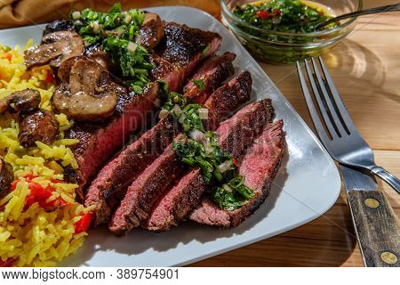 Juicy Rare Chimichurri Verde Grilled Club Steak With Yellow Rice And Mushrooms