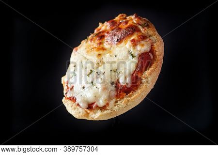 Fresh Baked Homemade English Muffin Pizza Flying Through The Air