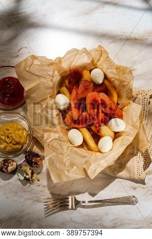 Peruvian Fast-food Salchipapas French Fries And Sliced Sausage With Hard-boiled Quail Eggs
