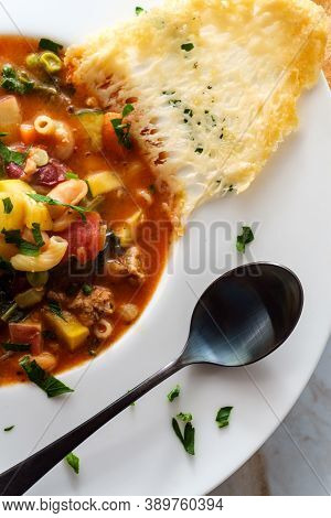 Hearty Italian Minestrone Soup With Sausage And Parmesan Cheese Crisp Plating