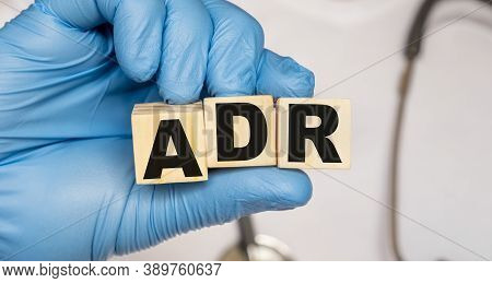 Adr Adverse Drug Reaction - Word From Wooden Blocks With Letters Holding By A Doctor's Hands In Medi