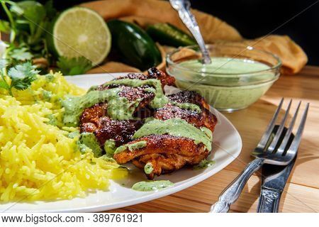 Peruvian Chicken Thighs With Aji Verde Green Cilantro Sauce And Yellow Rice