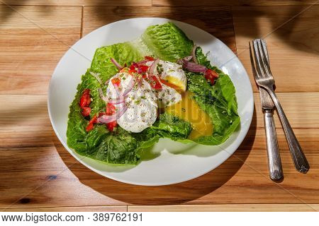 Poached Eggs With Runny Yolk On Bed Of Romaine Lettuce Topped With Red Onions Tomatoes Chives Salt A