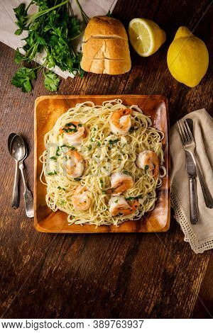 Shrimp Scampi With Angel Hair Pasta Surrounded By Cooking Ingredients