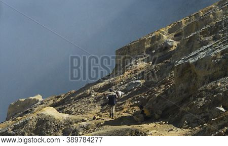 Banyuwangi, Indonesia - October 21,  2018 : The Sulphur Miner Work At The Top Of Mount Ijen Banyuwan