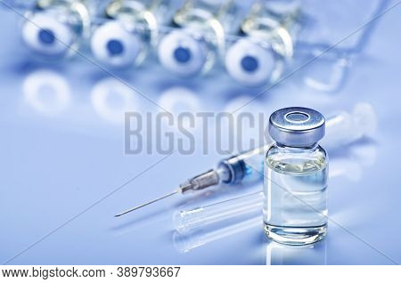 Single Use Syringe For Injection Treatment On Medical Table With Vials Of Liquid Drug Doses Flu Shot