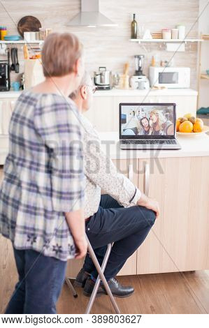Happy Senior Woman And Man Chatting With Family Via Internet Video Conference. Online Call With Daug