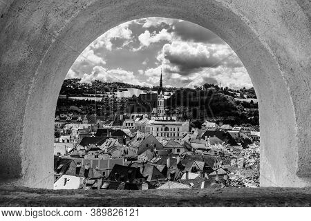 Cesky Krumlov - Arch Framed View Of Historical City Centre With St Vitus Church In The Middle. Cesky