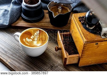 Latte Art Barista Cappuccino On Wooden Table With Coffee Grinder, Coffee Maker And Coffee Beans