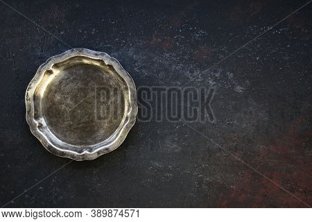Empty Silver Vintage Plate On Dark Concrete Background. Top View With Copy Space