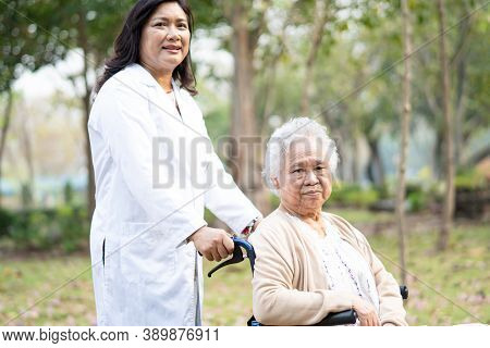 Doctor Help And Care Asian Senior Or Elderly Old Lady Woman Patient Sitting On Wheelchair At Park In