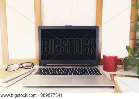 Comfortable Workplace For Work Or Study. A Desktop With A Computer, Notebooks, Books, Glasses And A 