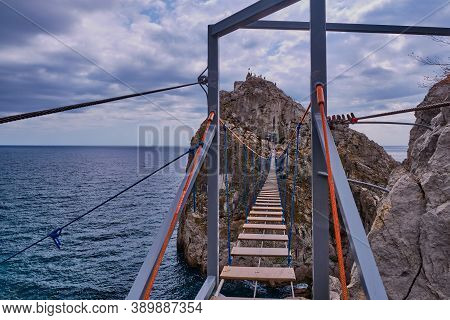 The Suspension Bridge To Rock Diva. The Black Sea Coast Near Yalta, Town Simeiz, Crimea. Coastal Sea