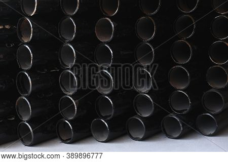 Black Metal Pipes For Gasification Or Water Supply. Industrial Background Close Up