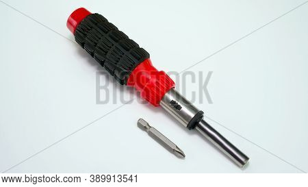 Reversible Screwdriver With Nozzle. On A White Background. Universal Tool For A Twist.