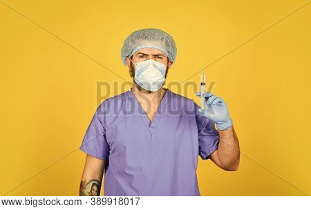Coronavirus Epidemic From China. Mature Doctor Use Syringe In Respirator Mask. Skilled Nurse Make In