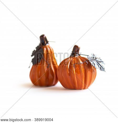 A Ceramic Halloween Pumpkins With Brown Matel Leaves Isolated Against A White Background. Orange Hal