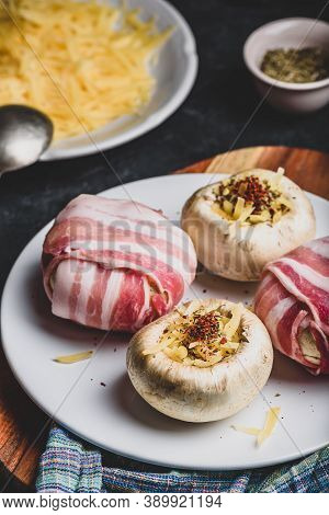 Preparing Of Bacon-wrapped Button Mushrooms Stuffed With Grated Cheddar Cheese And