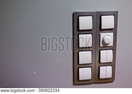 Set Of Modern Lightswitch On Grey Wall. Electronic Light Switch. Smart Home Appliances And Lighting