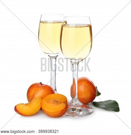 Delicious Plum Liquor And Ripe Fruits On White Background. Homemade Strong Alcoholic Beverage